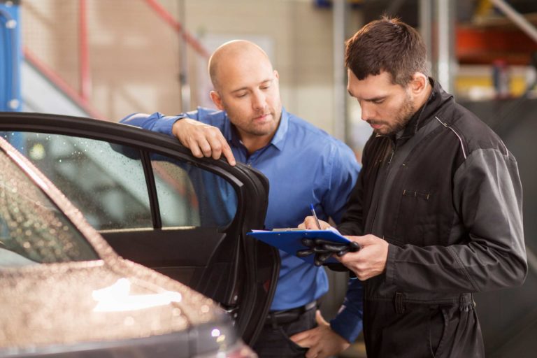 auto-mechanic-and-customer-at-car-shop-PGXFAJH