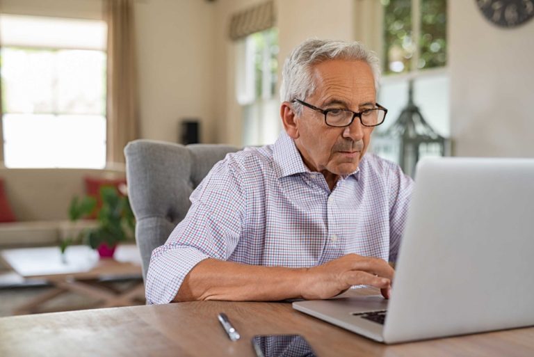 senior-man-using-laptop-P3XJ6RE